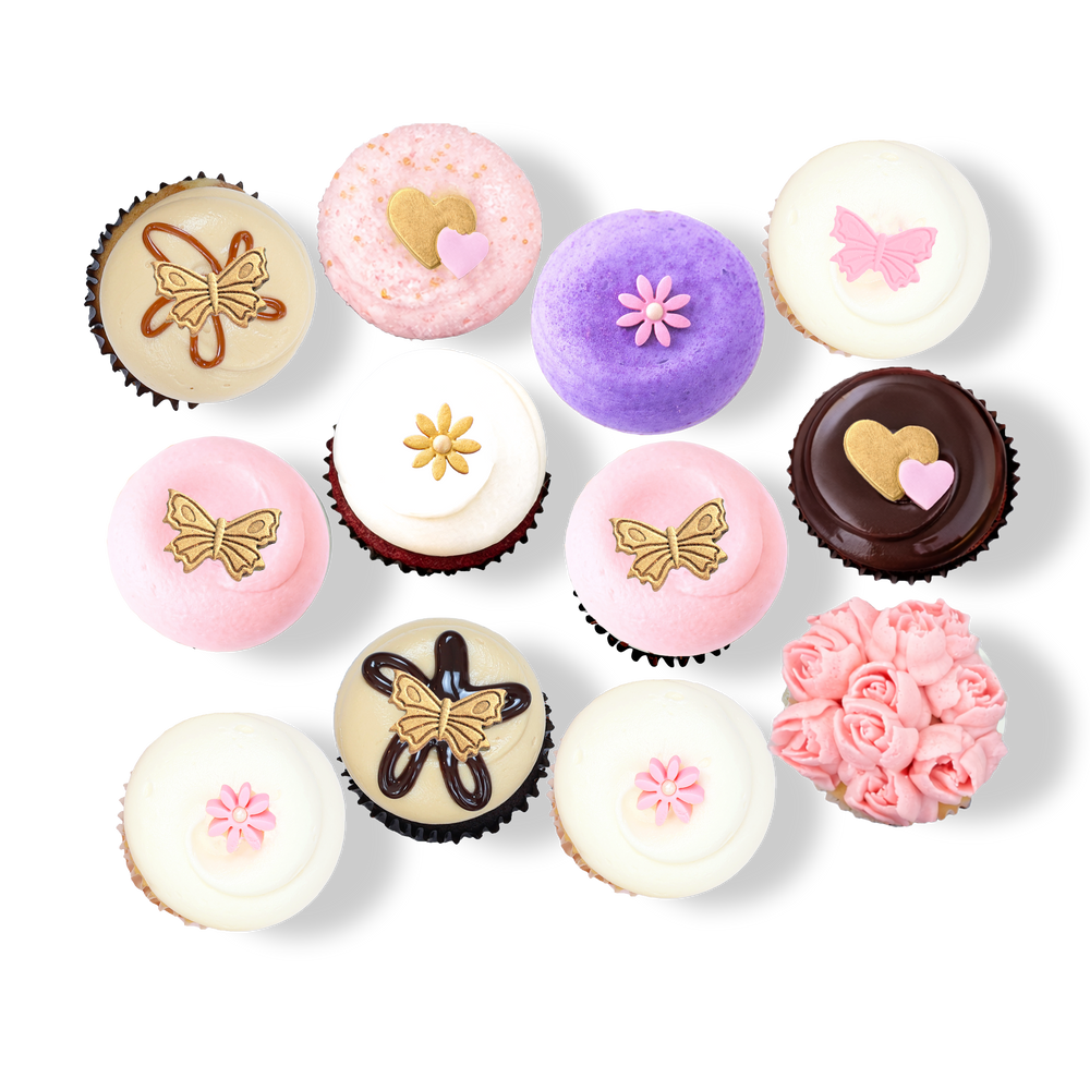 Cupcakes with pastel frosting, butterflies, flowers, and gold heart toppers